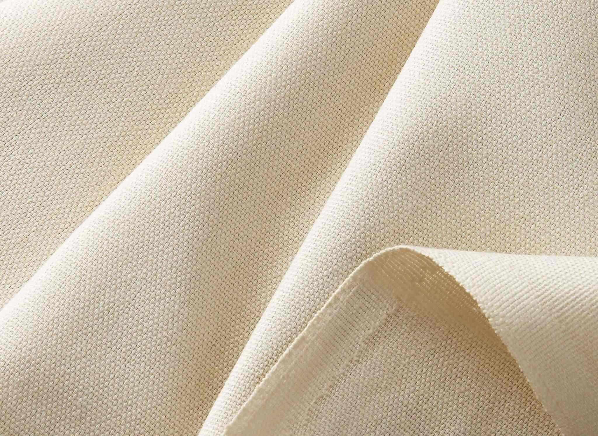 Close-up of natural artist canvas fabric showing its woven texture