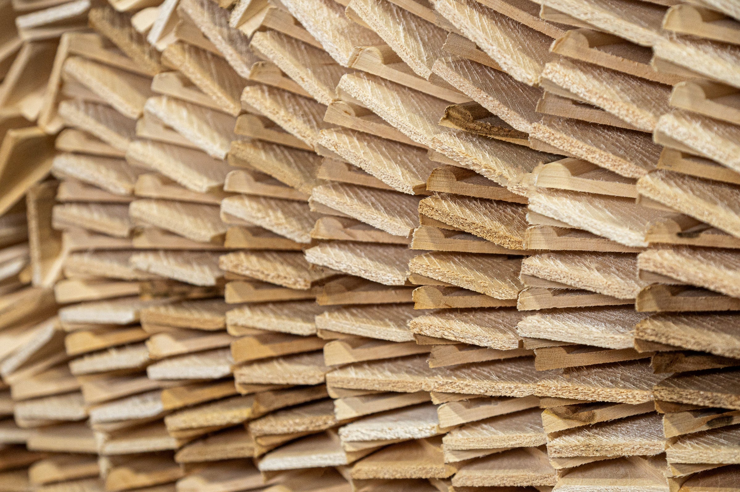 Stacked Apollon 64 Series wooden stretcher bars in the workshop