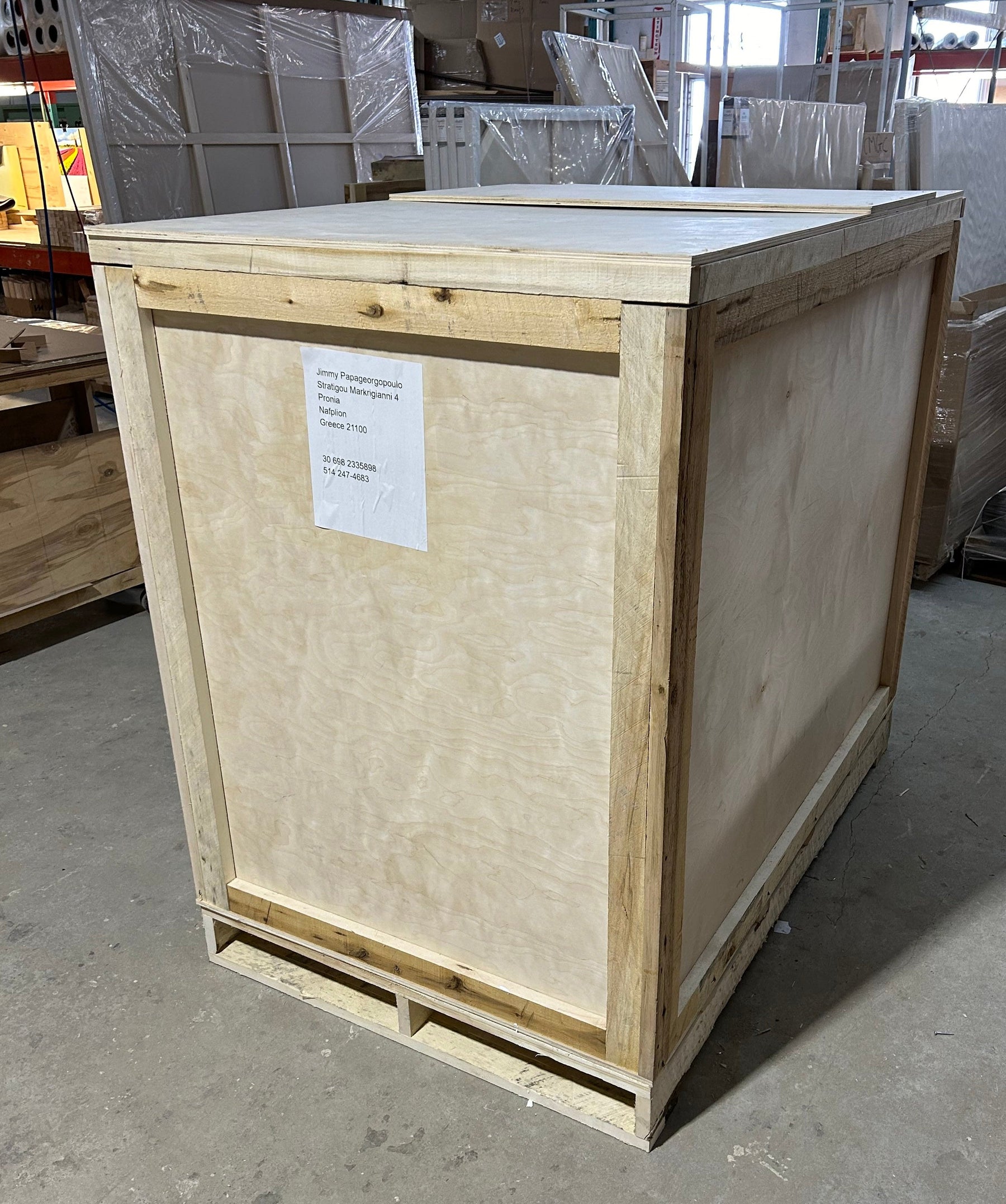 A large wooden shipping crate on a pallet, photographed in the Apollon warehouse.