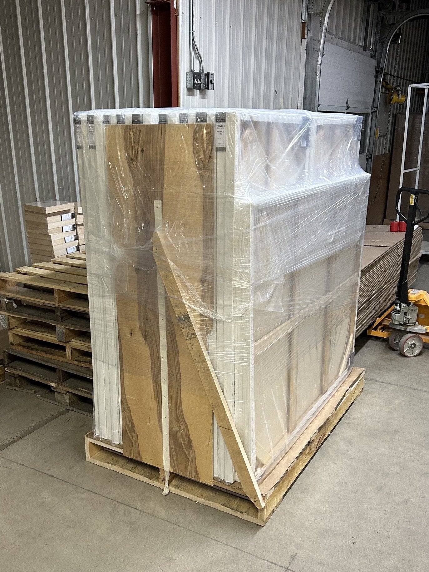 Apollon artist canvases stacked and secured on a wooden freight pallet