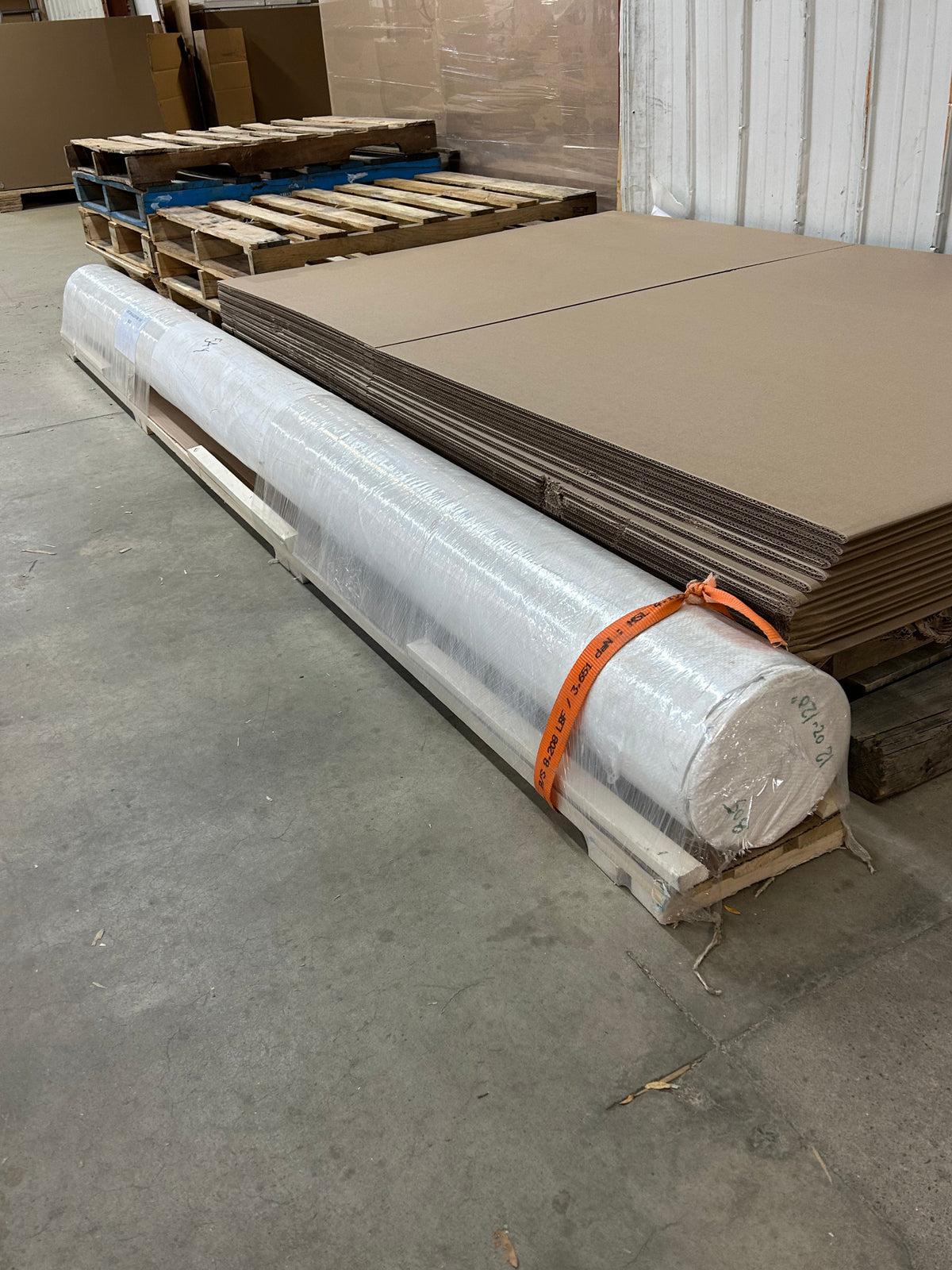 A long roll of Apollon cotton canvas (120 feet long) packed for shipping in the Apollon warehouse.