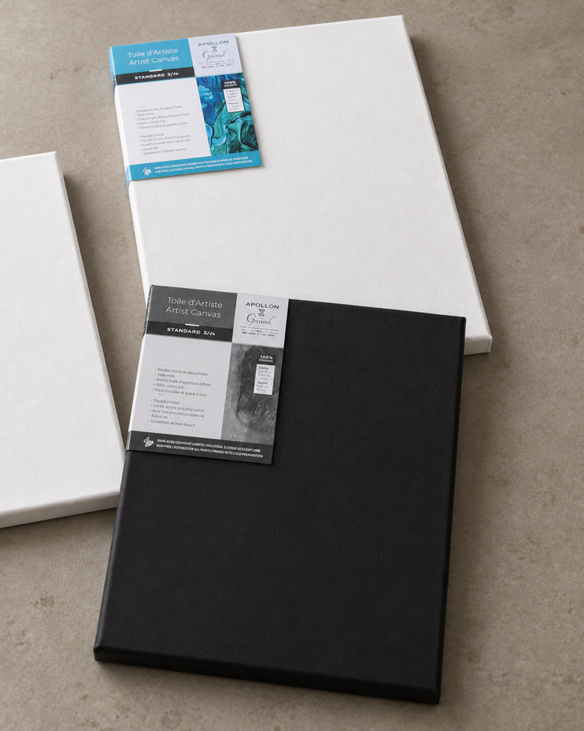 Two canvas with packaging tags, one in white and one in black, arranged on a textured beige surface.